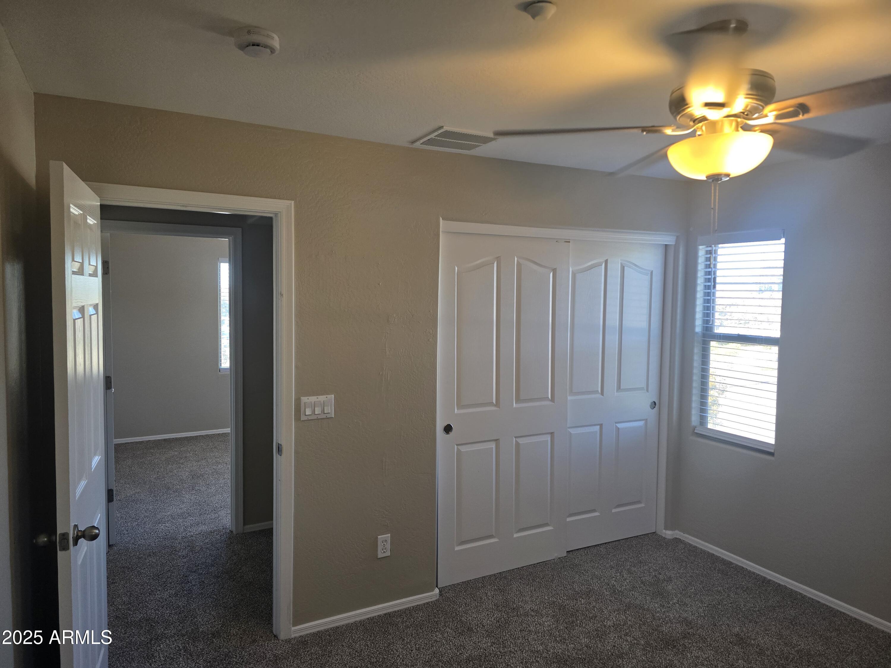 2644 East Megan Street Gilbert, AZ 85295 - Photo 13 of 21 wooden floor in an empty room with a window