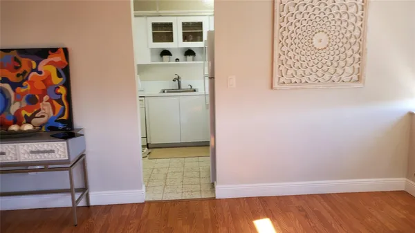 an empty room with wooden floor and closet