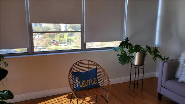 a view of a workspace with furniture window and wooden floor