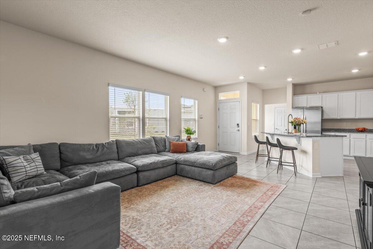 164 Java Lane St. Augustine, FL 32092 - Photo 11 of 57 a living room with furniture and a large window