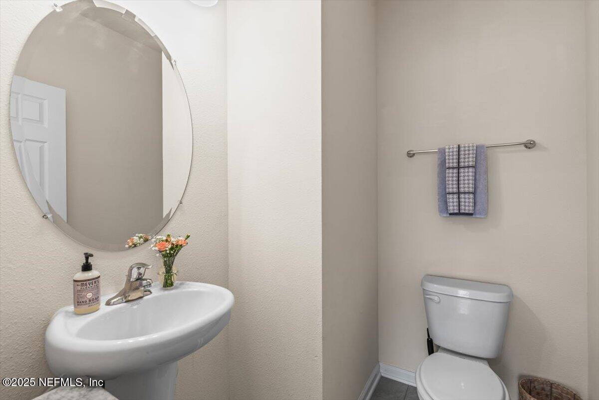 164 Java Lane St. Augustine, FL 32092 - Photo 13 of 57 a bathroom with a toilet sink and mirror