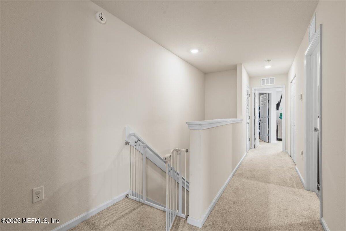 164 Java Lane St. Augustine, FL 32092 - Photo 17 of 57 a view of a hallway with staircase