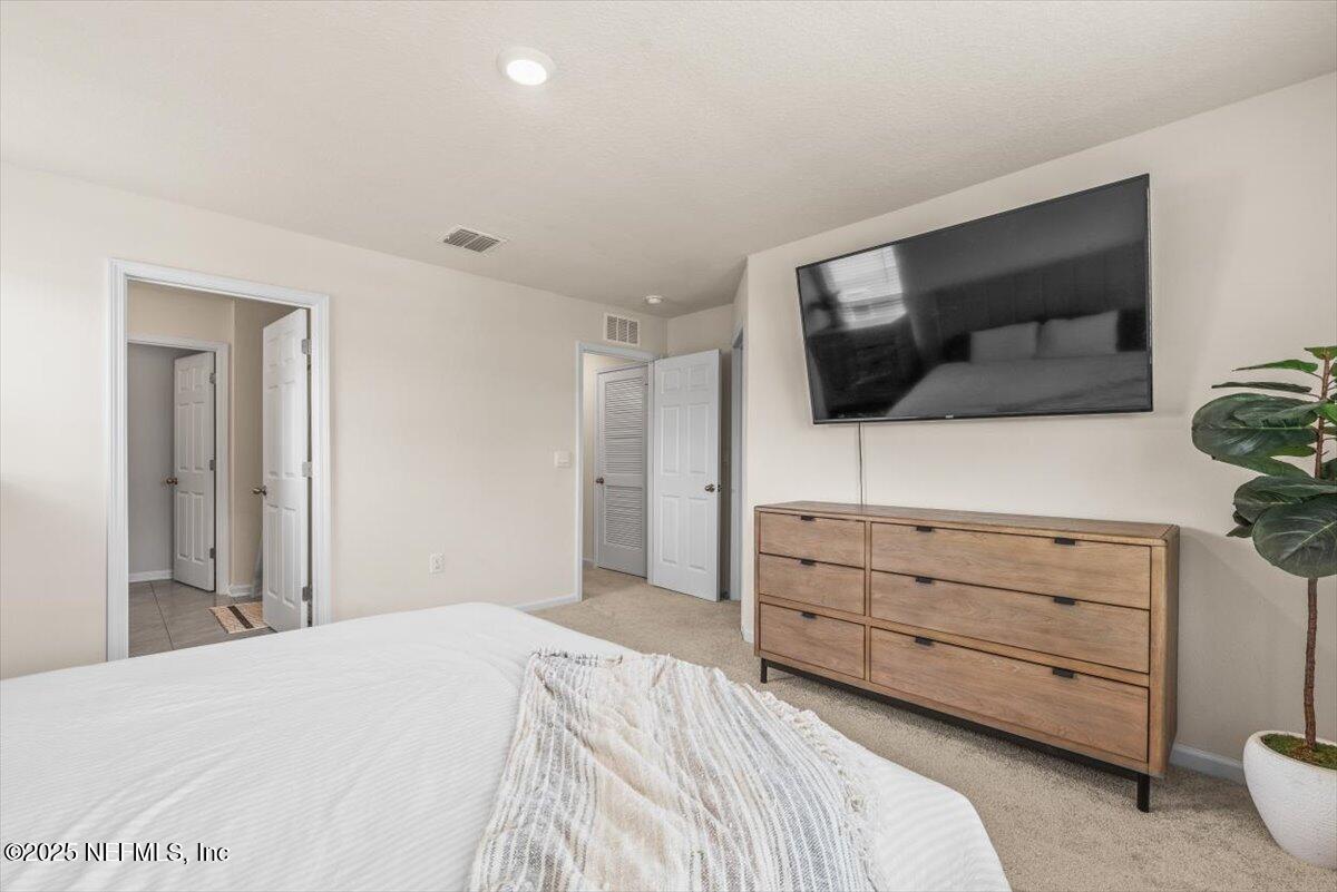 164 Java Lane St. Augustine, FL 32092 - Photo 20 of 57 a bedroom with a bed and a flat screen tv