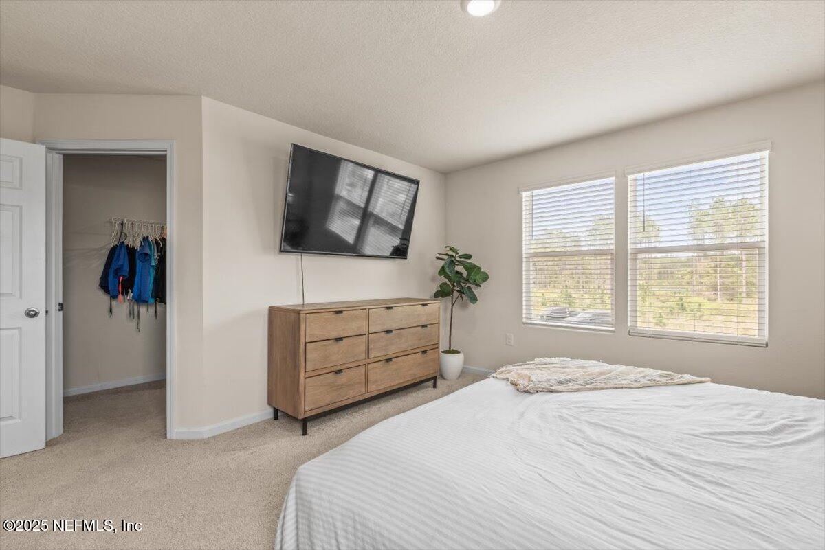 164 Java Lane St. Augustine, FL 32092 - Photo 21 of 57 a bedroom with a bed and a flat screen tv