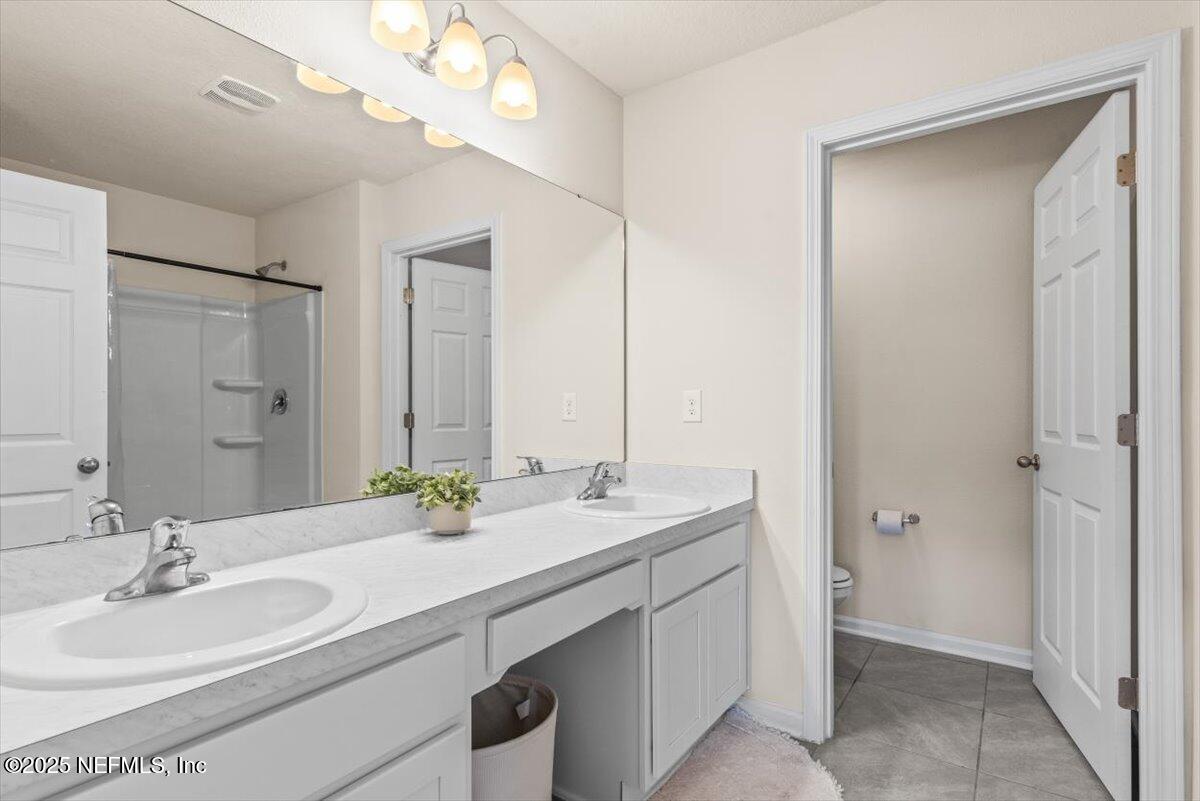 164 Java Lane St. Augustine, FL 32092 - Photo 22 of 57 a bathroom with a double vanity sink and a mirror