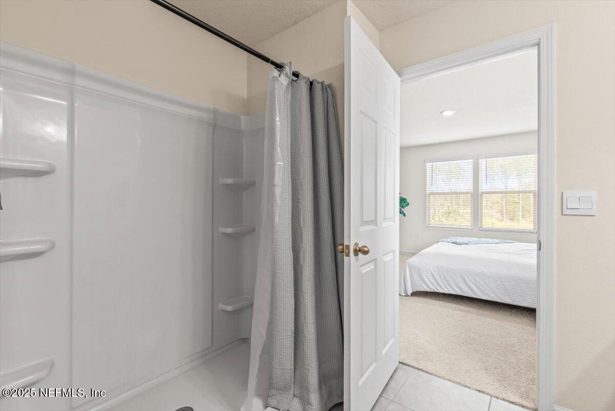 164 Java Lane St. Augustine, FL 32092 - Photo 24 of 57 a en suite bathroom with a sink and a shower