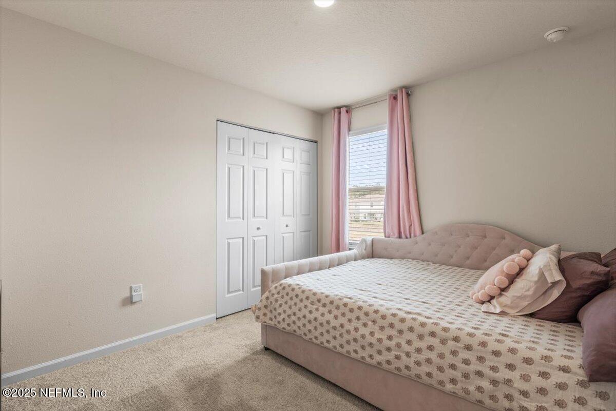 164 Java Lane St. Augustine, FL 32092 - Photo 26 of 57 a bedroom with a bed and a window