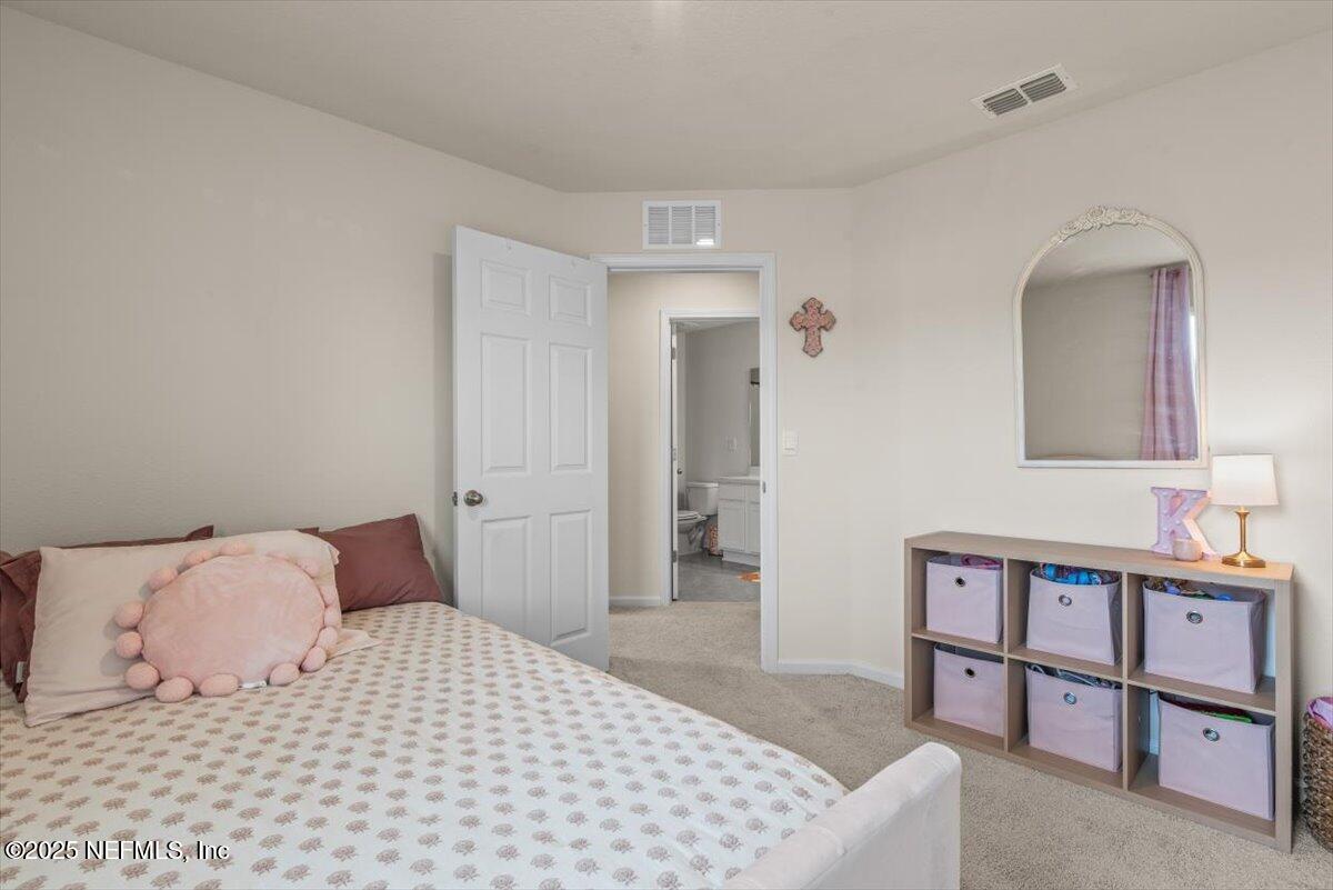 164 Java Lane St. Augustine, FL 32092 - Photo 27 of 57 a bedroom with a bed and a dresser