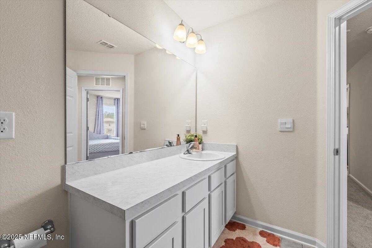 164 Java Lane St. Augustine, FL 32092 - Photo 29 of 57 a bathroom with a sink vanity and a mirror