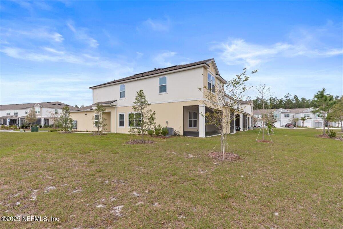 164 Java Lane St. Augustine, FL 32092 - Photo 36 of 57 a view of a big house with a big yard and large tree