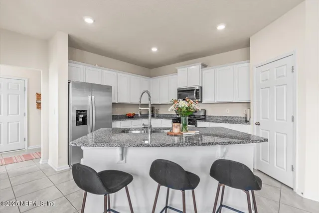 a kitchen with stainless steel appliances granite countertop a sink and cabinets
