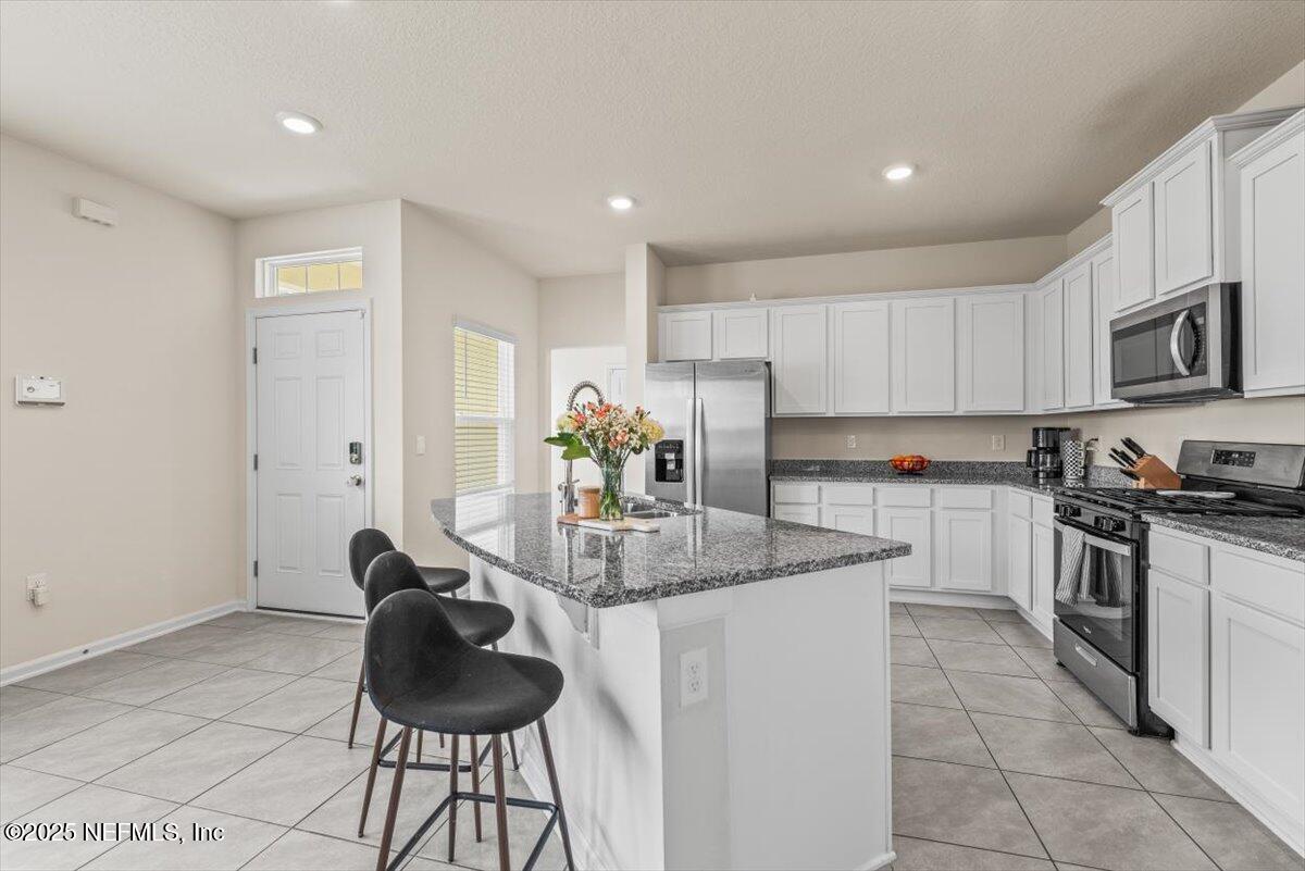 164 Java Lane St. Augustine, FL 32092 - Photo 5 of 57 a kitchen with stainless steel appliances granite countertop a sink and cabinets