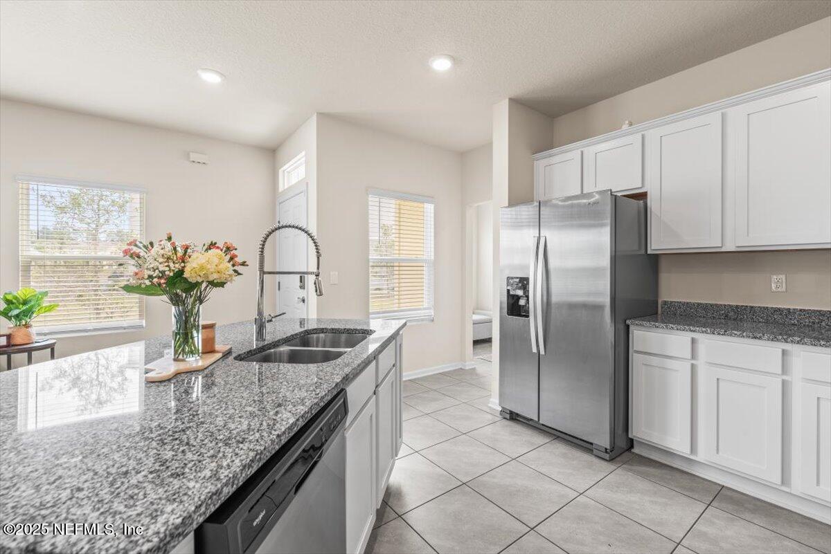 164 Java Lane St. Augustine, FL 32092 - Photo 6 of 57 a kitchen with granite countertop a sink and stainless steel appliances