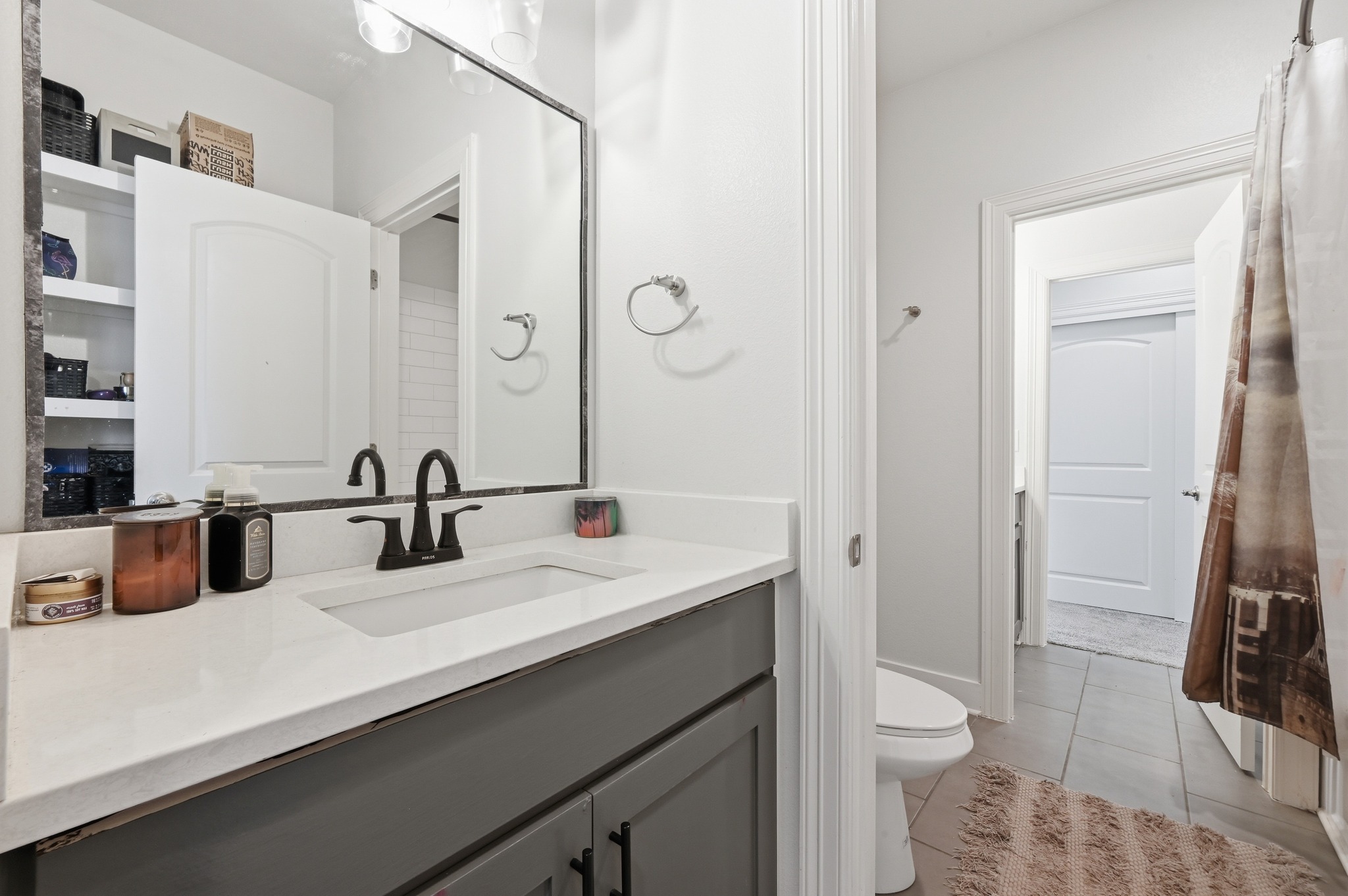 592 Farm To Market 967, Unit B Buda, TX 78610 - Photo 21 of 26 Designed with both style and convenience in mind, this well-appointed full bath features a modern vanity and plenty of counter space for everyday living.