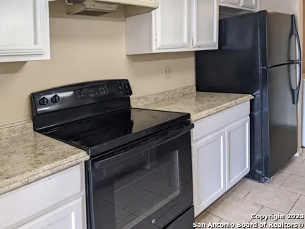 a kitchen with granite countertop cabinets and steel stainless steel appliances