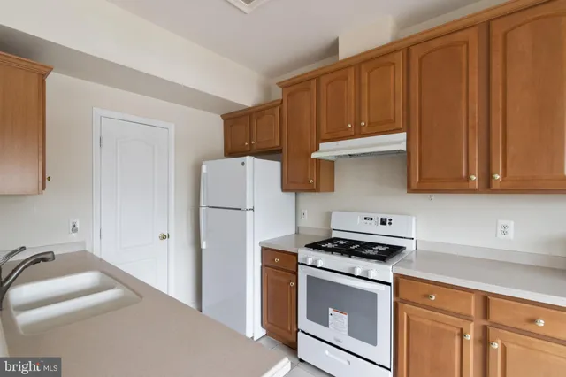 a kitchen with stainless steel appliances granite countertop a refrigerator sink and cabinets