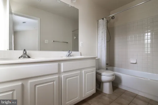 a bathroom with a double vanity sink toilet and shower