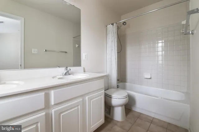 a bathroom with a sink toilet double vanity and shower