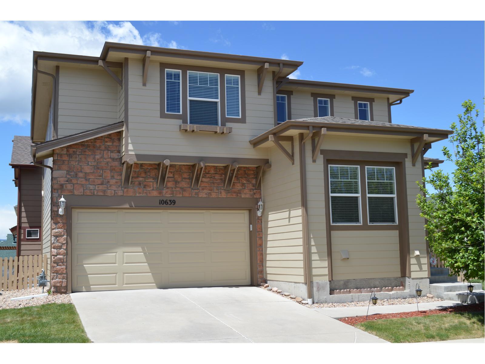 10639 Cherrybrook Circle Highlands Ranch, CO 80126 - Photo 1 of 1 a front view of a house with garden