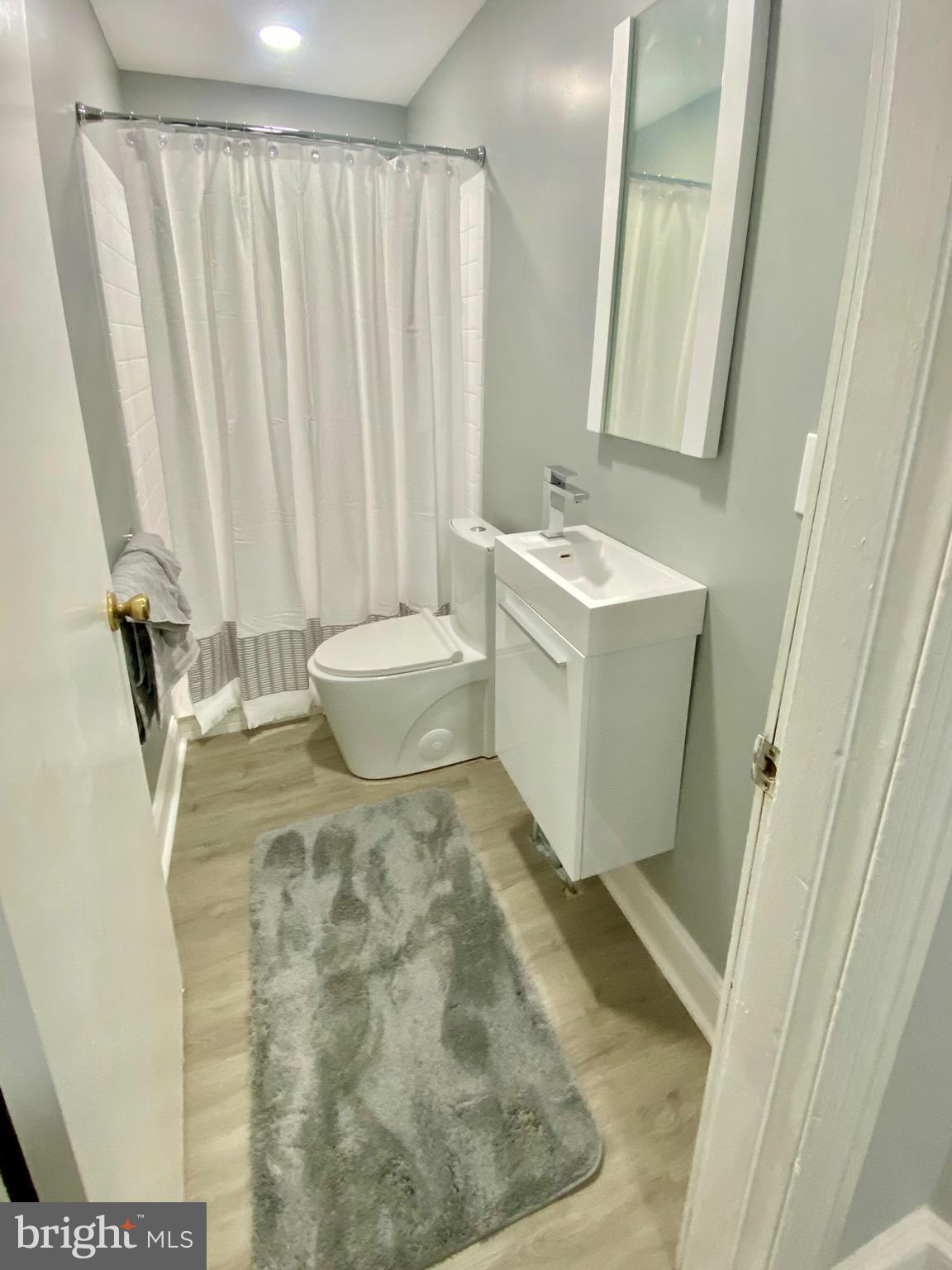 4404 Leiper Street Philadelphia, PA 19124 - Photo 11 of 14 a bathroom with a sink and a mirror