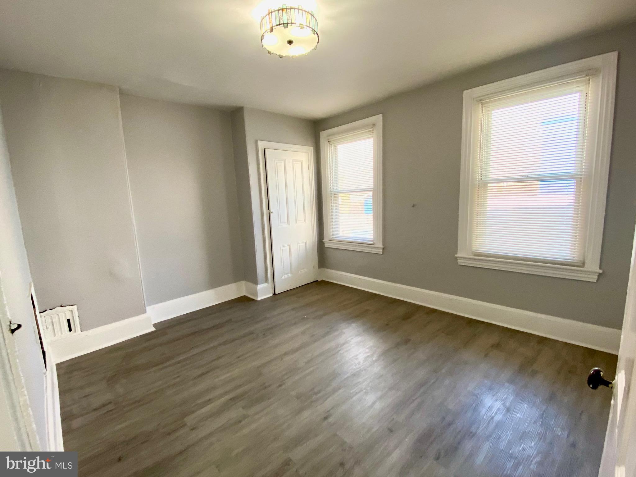4404 Leiper Street Philadelphia, PA 19124 - Photo 13 of 14 an empty room with wooden floor and windows