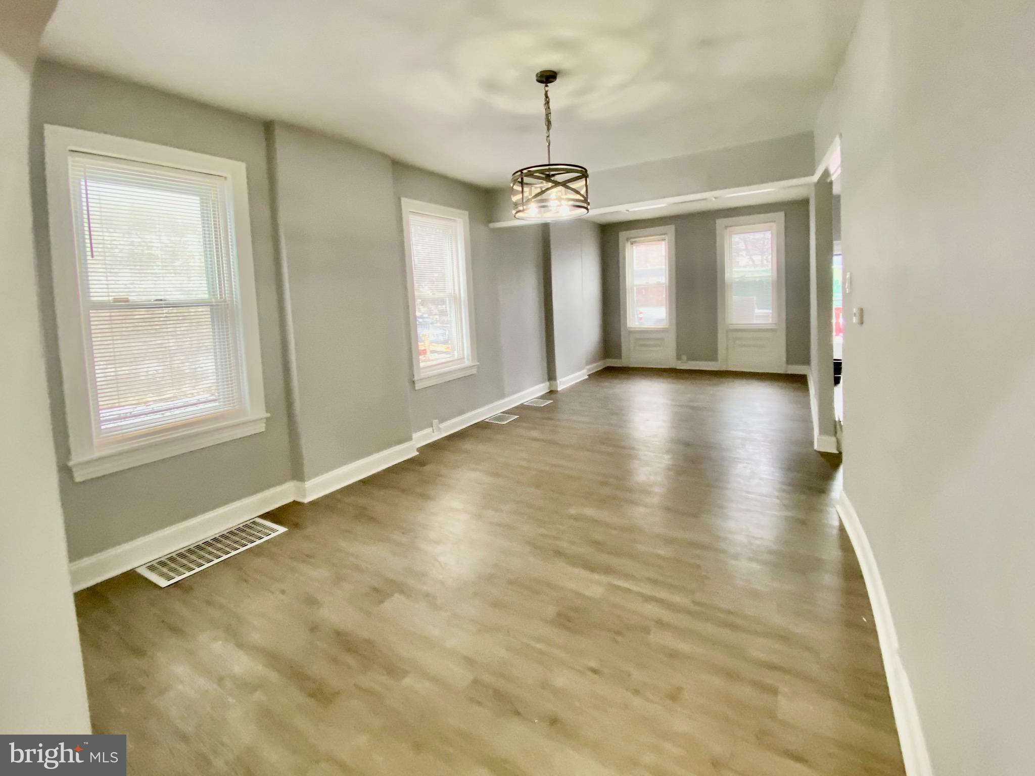 4404 Leiper Street Philadelphia, PA 19124 - Photo 4 of 14 a view of an empty room with window and wooden floor