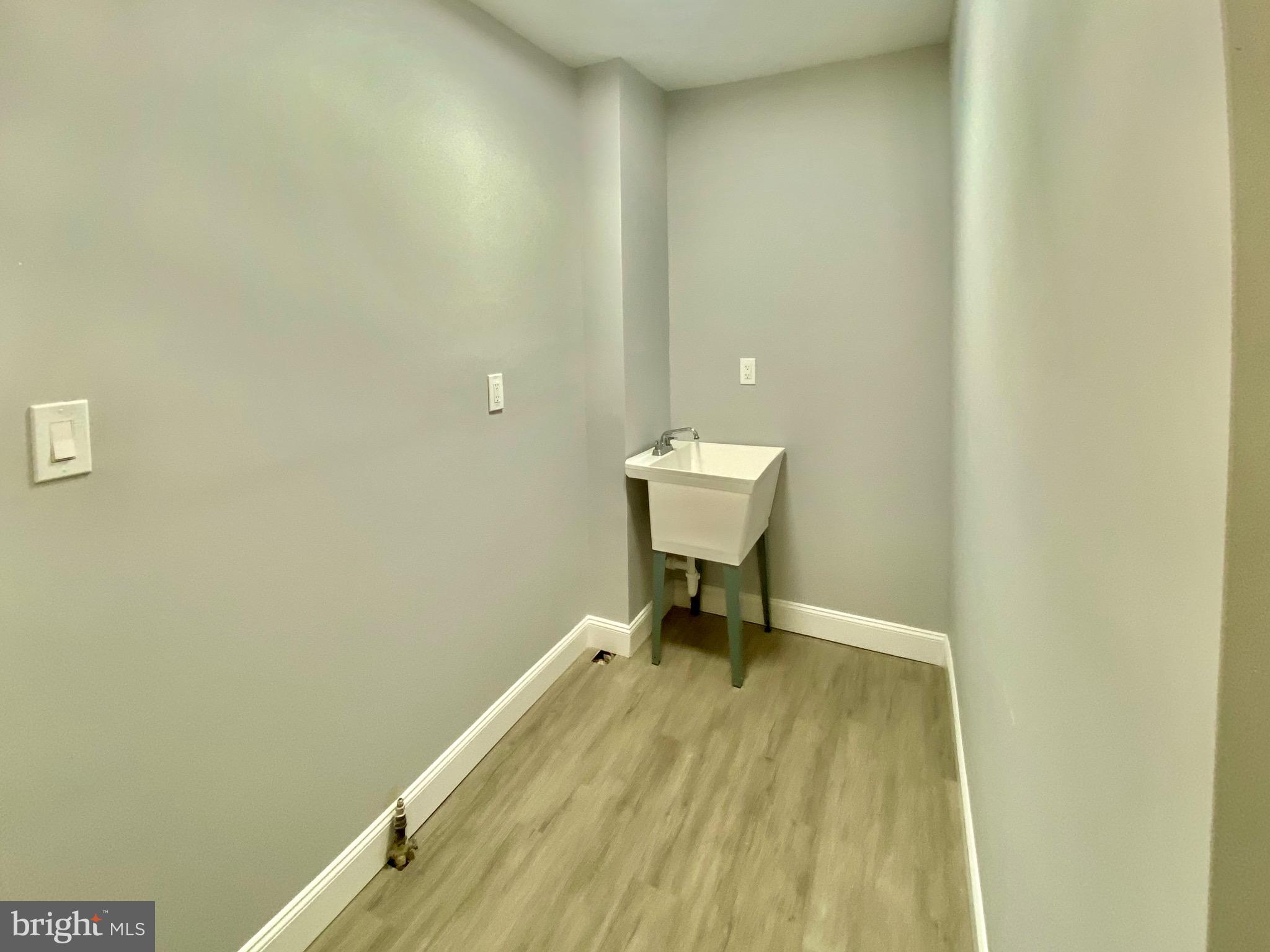 4404 Leiper Street Philadelphia, PA 19124 - Photo 7 of 14 a view of a room with wooden floor and a chair