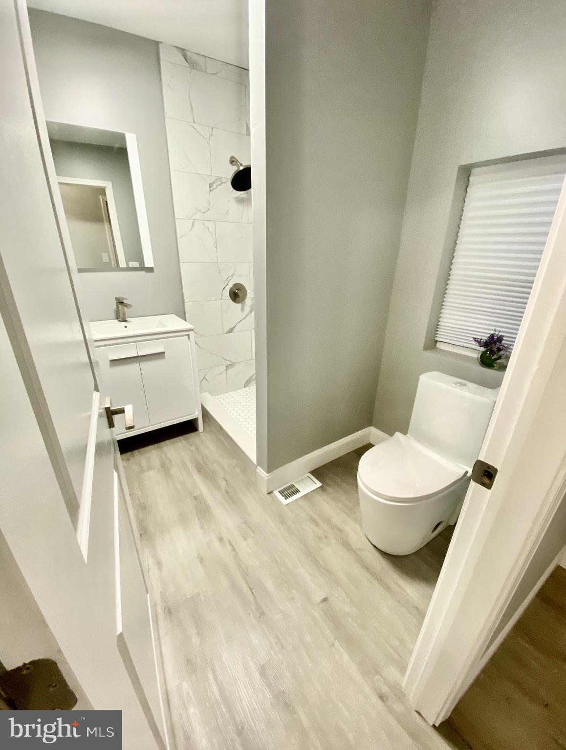 4404 Leiper Street Philadelphia, PA 19124 - Photo 8 of 14 a bathroom with a sink a toilet and a shower