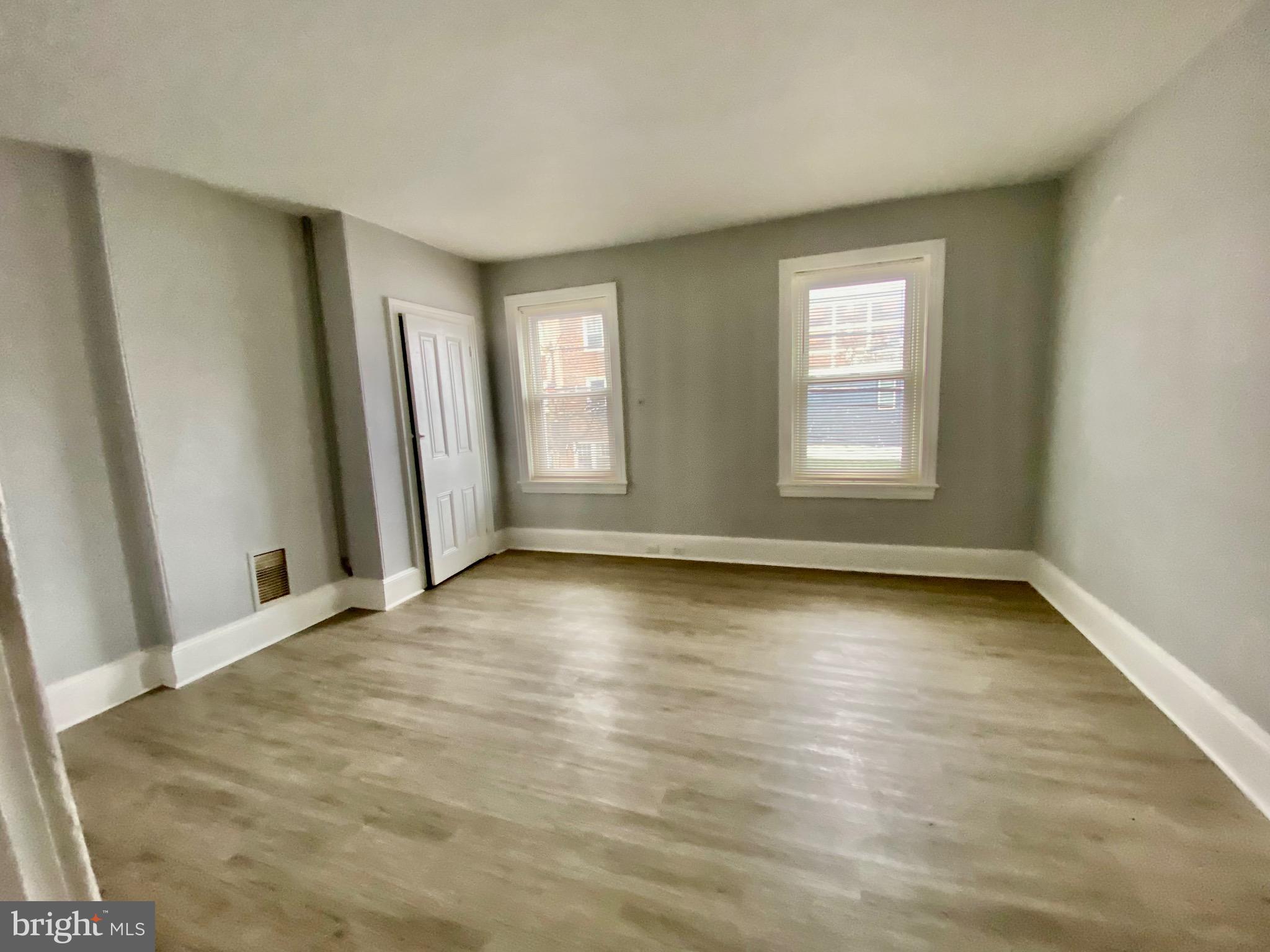 4404 Leiper Street Philadelphia, PA 19124 - Photo 9 of 14 an empty room with wooden floor and windows