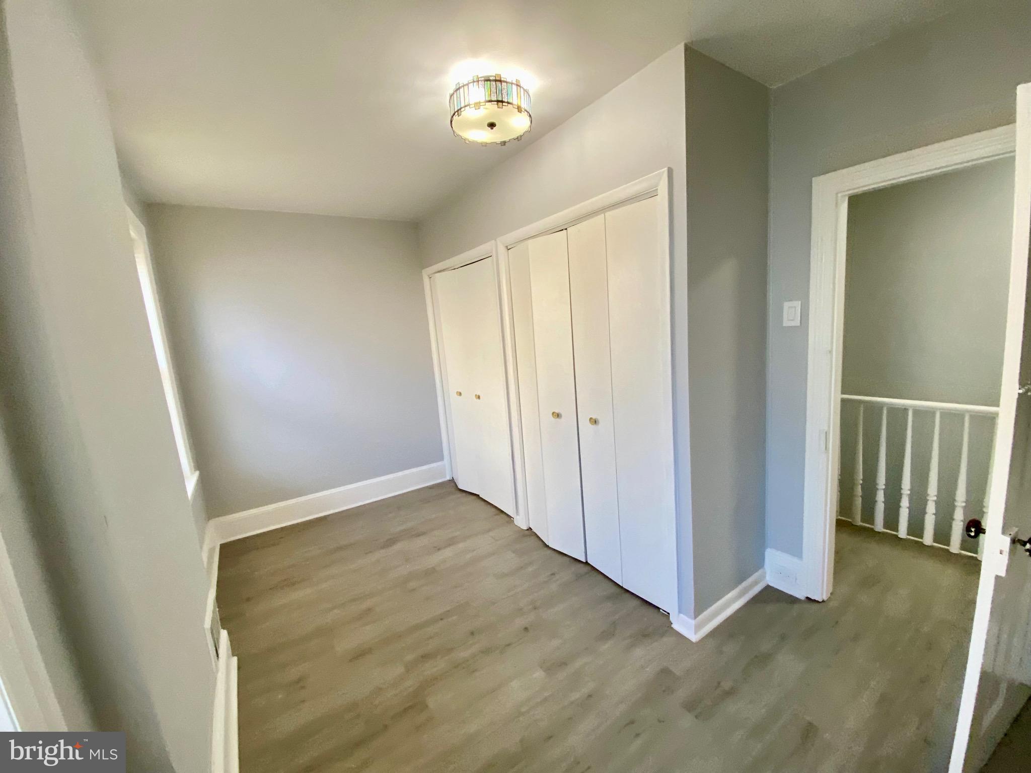 4404 Leiper Street Philadelphia, PA 19124 - Photo 10 of 14 an empty room with wooden floor and windows