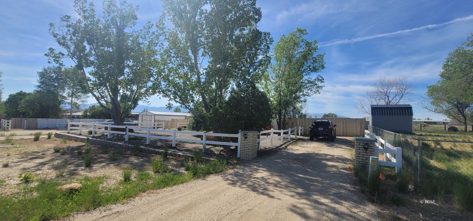 933 Spring Valley Parkway Spring Creek, NV 89815 - Photo 3 of 27 a view of a backyard with wooden fence