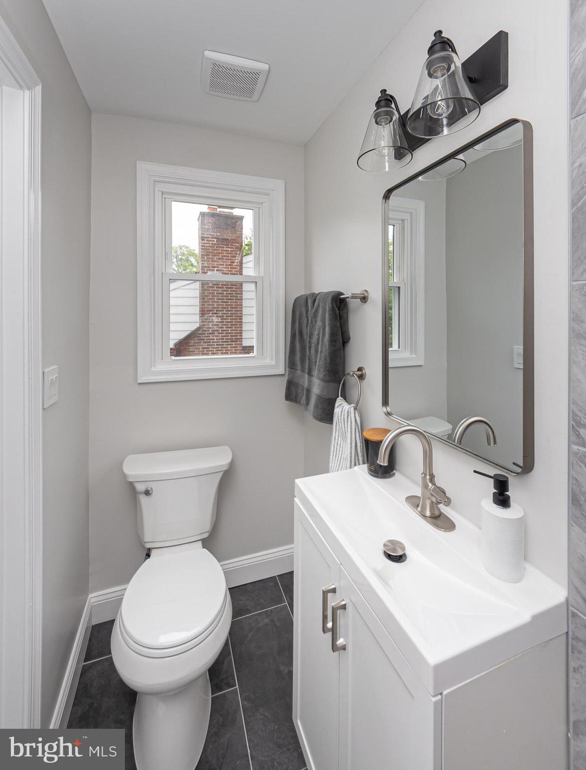 536 Brook Road Towson, MD 21286 - Photo 19 of 39 a bathroom with a toilet sink and mirror