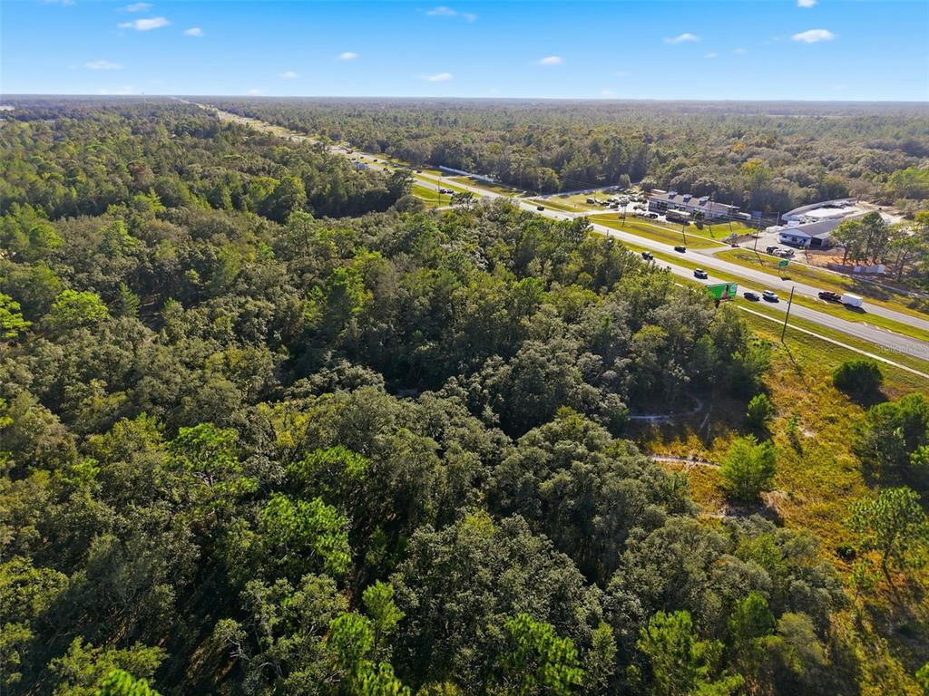 11254 Commercial Way Weeki Wachee, FL 34614 - Photo 5 of 15 an aerial view of residential houses with city and green space