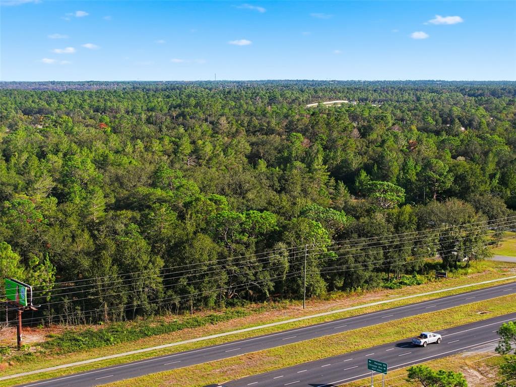 11254 Commercial Way Weeki Wachee, FL 34614 - Photo 8 of 15 a view of a yard with an outdoor space