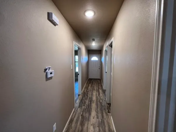 a view of hallway with wooden floor