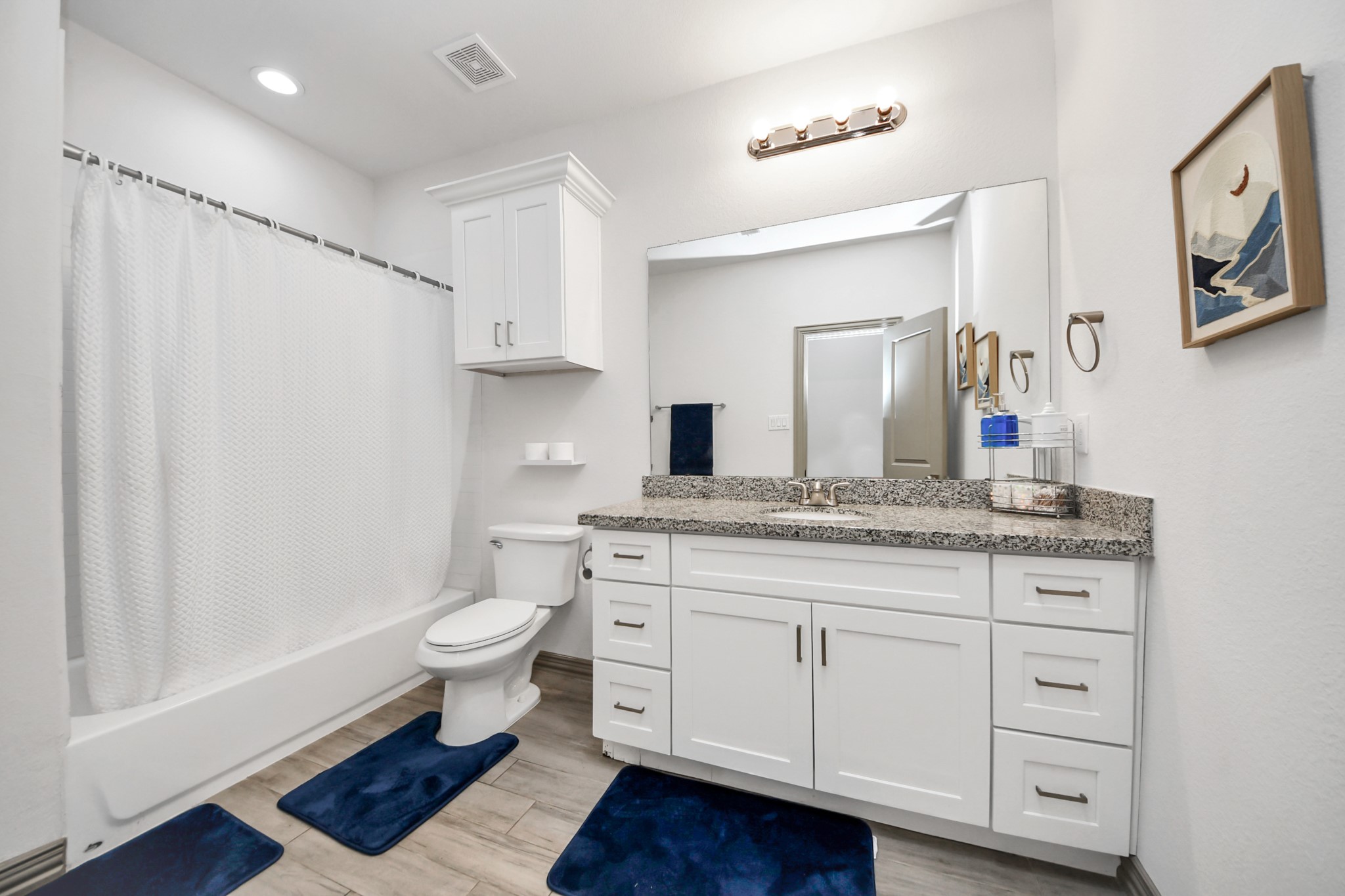 5334 Pershing Street Houston, TX 77033 - Photo 21 of 43 a bathroom with a granite countertop sink toilet a large mirror a vanity and shower