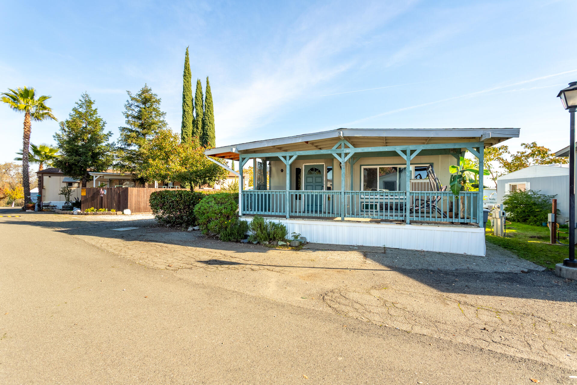 a front view of a house with a yard and potted plants