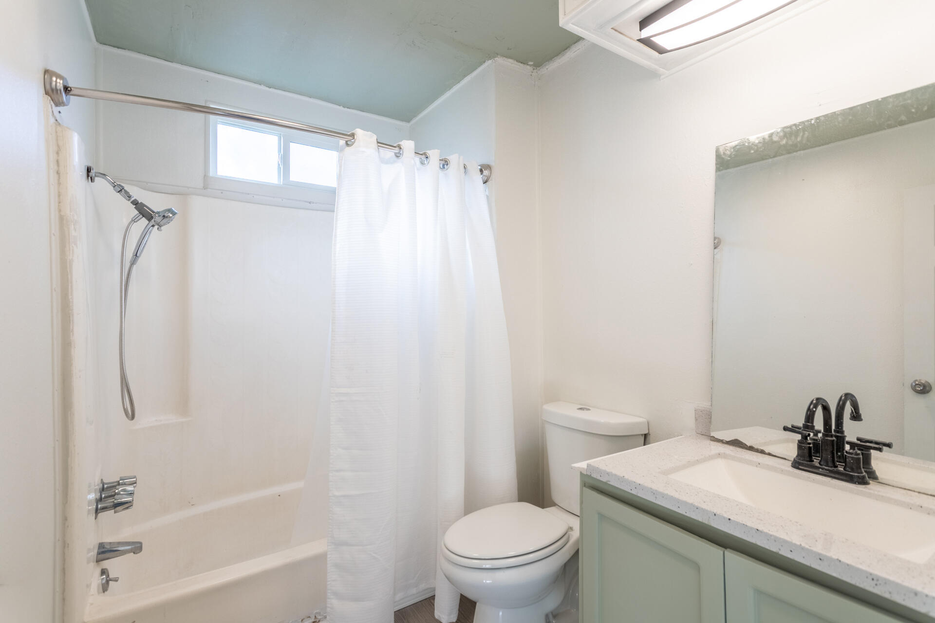 11037 Erickson Way, Unit 76 Redding, CA 96003 - Photo 11 of 13 a bathroom with a sink a toilet and shower