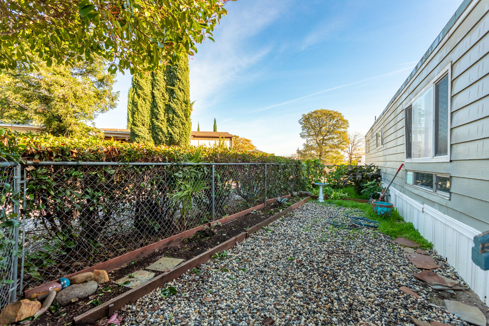 11037 Erickson Way, Unit 76 Redding, CA 96003 - Photo 12 of 13 a view of a pathway of a yard with wooden fence