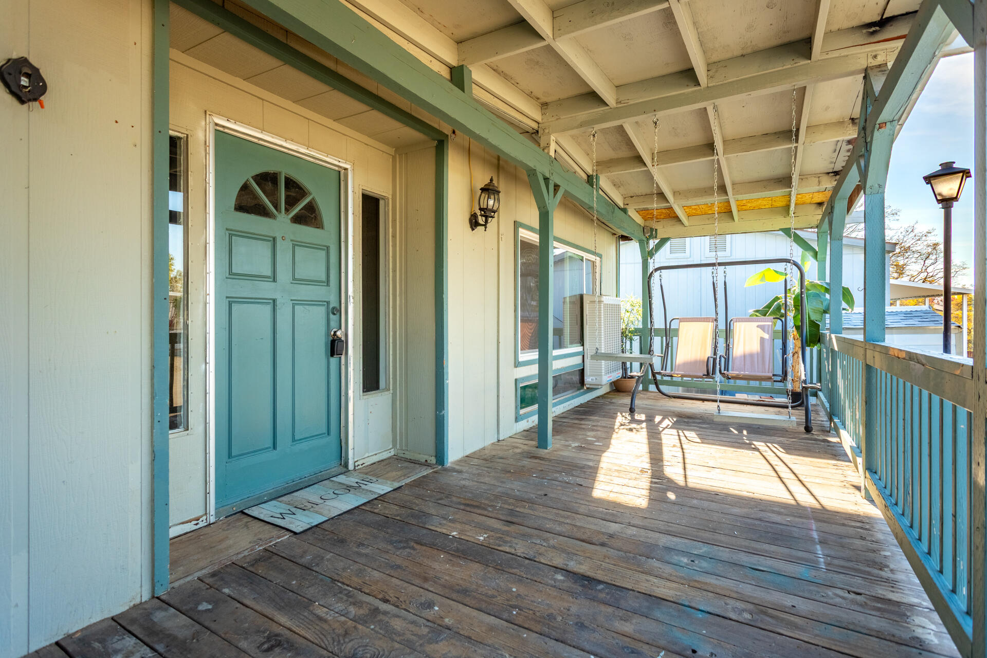 11037 Erickson Way, Unit 76 Redding, CA 96003 - Photo 2 of 13 a view of a porch with wooden floor and furniture