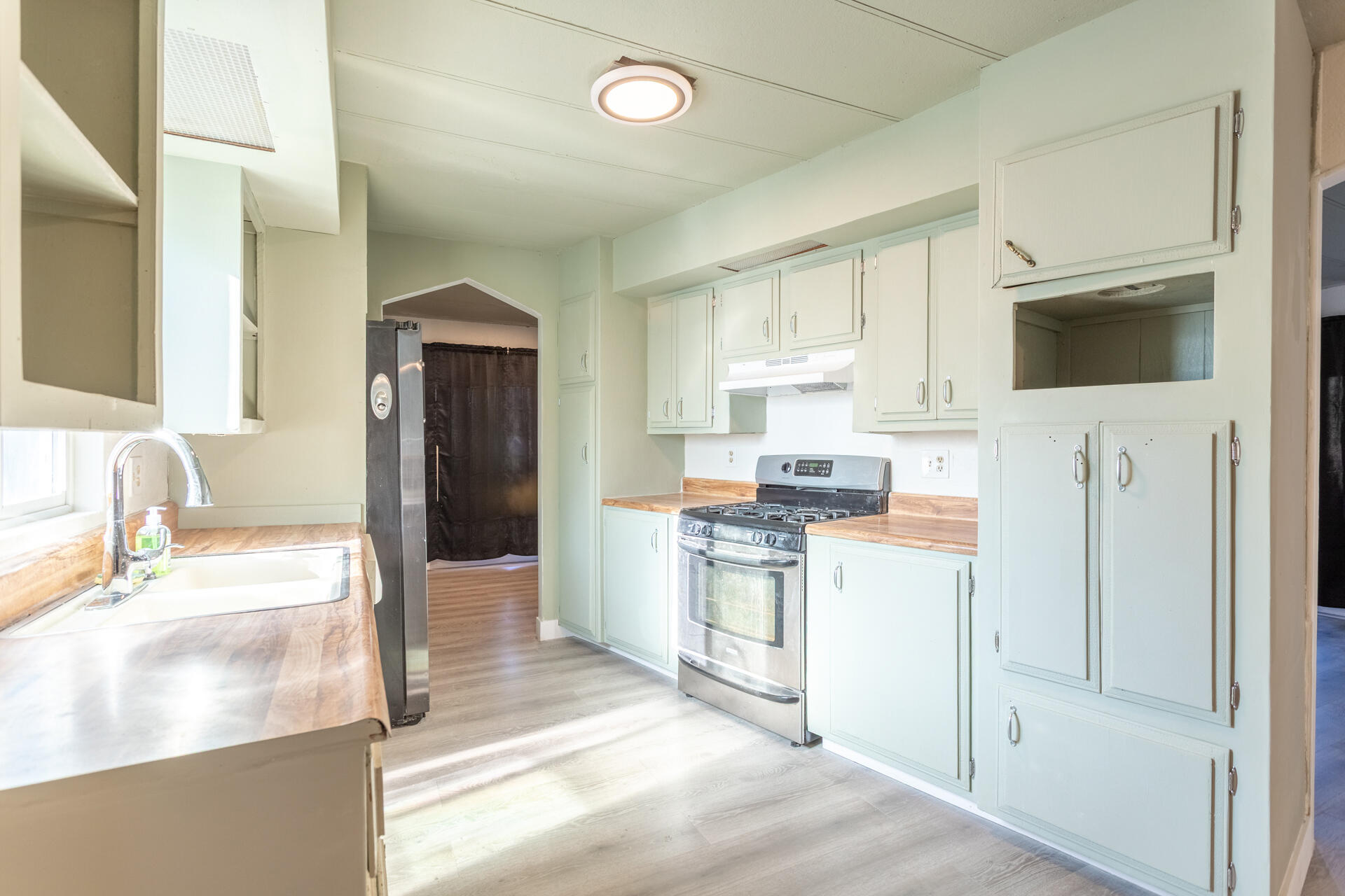 11037 Erickson Way, Unit 76 Redding, CA 96003 - Photo 4 of 13 a kitchen with stainless steel appliances granite countertop a refrigerator and a stove top oven