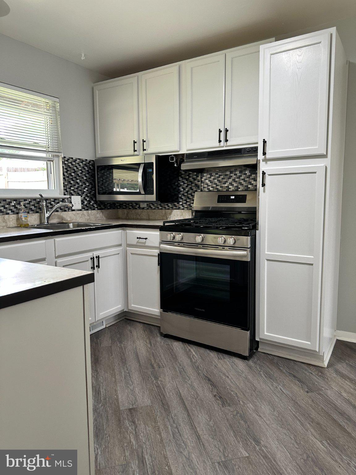 8336 Scotts Level Road Baltimore, MD 21208 - Photo 16 of 55 Modern kitchen with sleek finishes.