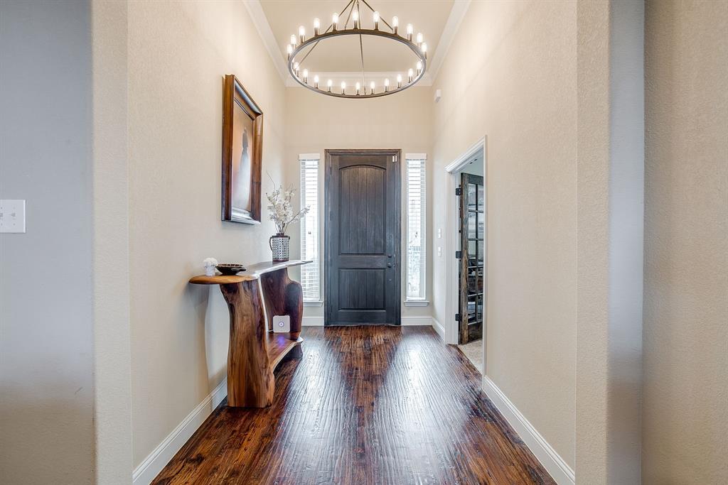 7320 Spring Ranch Court Godley, TX 76044 - Photo 18 of 40 a view of a hallway with wooden floor and staircase
