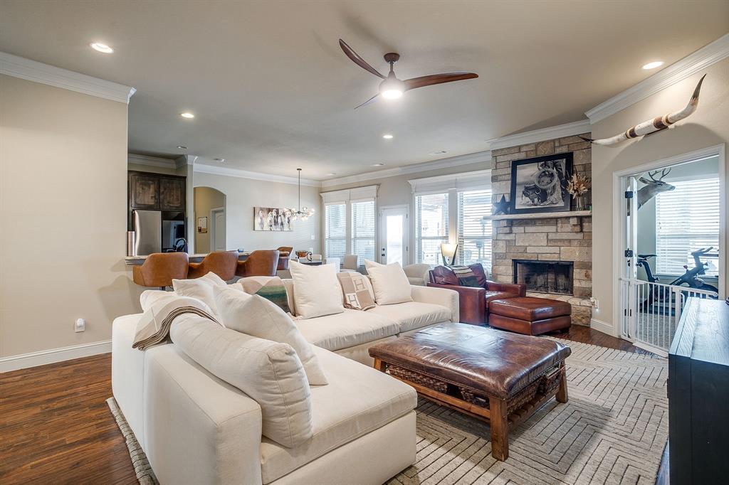 7320 Spring Ranch Court Godley, TX 76044 - Photo 19 of 40 a living room with furniture a fireplace and a chandelier