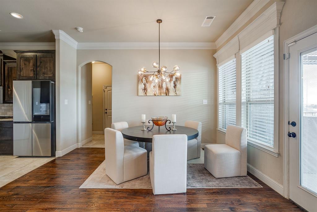 7320 Spring Ranch Court Godley, TX 76044 - Photo 23 of 40 a view of a dining room with furniture wooden floor and a chandelier