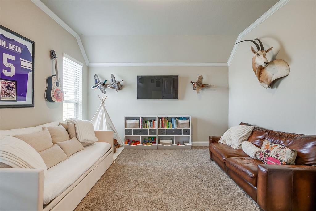 7320 Spring Ranch Court Godley, TX 76044 - Photo 26 of 40 a living room with furniture and a flat screen tv