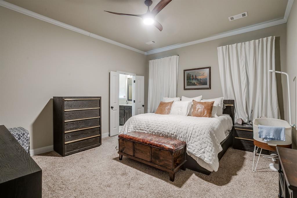 7320 Spring Ranch Court Godley, TX 76044 - Photo 28 of 40 a spacious bedroom with a bed and a couch