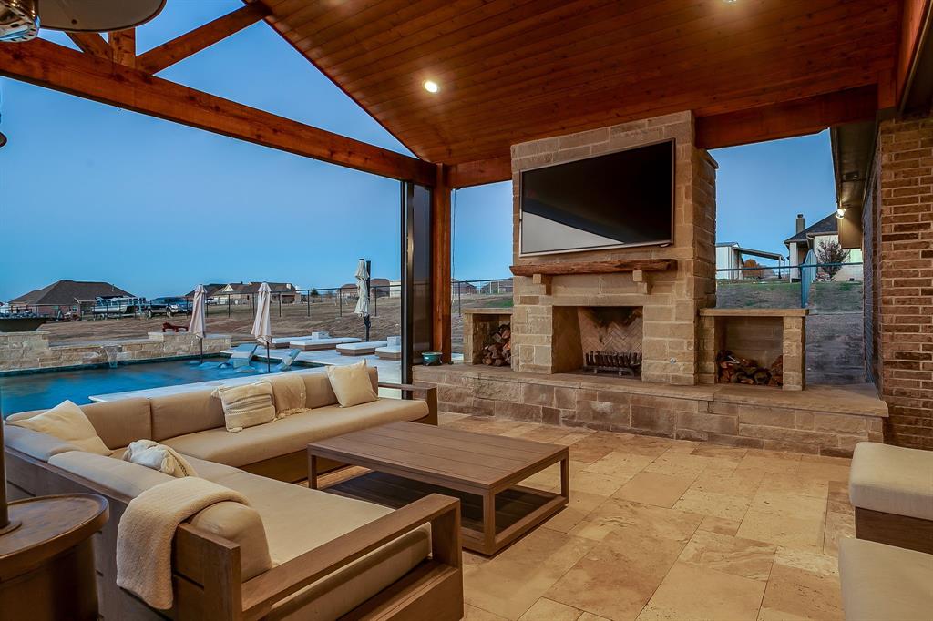 7320 Spring Ranch Court Godley, TX 76044 - Photo 3 of 40 a living room with furniture a fireplace and a flat screen tv