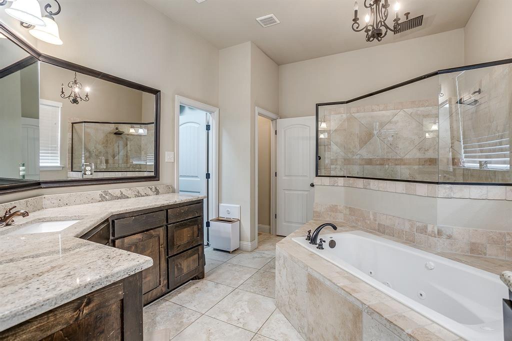 7320 Spring Ranch Court Godley, TX 76044 - Photo 32 of 40 a bathroom with a tub a sink and mirror
