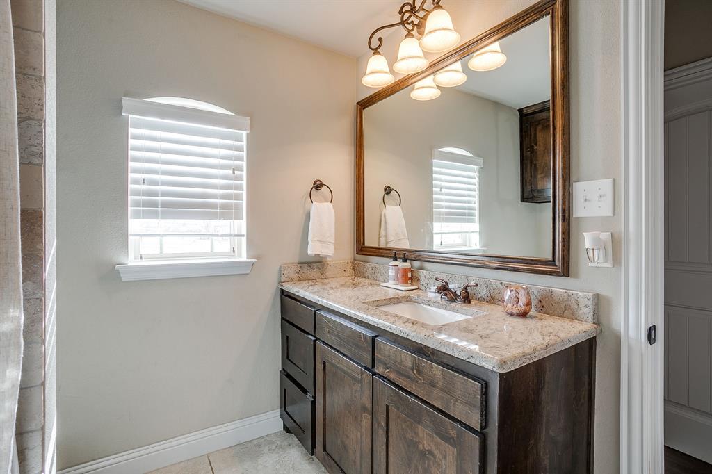 7320 Spring Ranch Court Godley, TX 76044 - Photo 34 of 40 a bathroom with a sink and a mirror